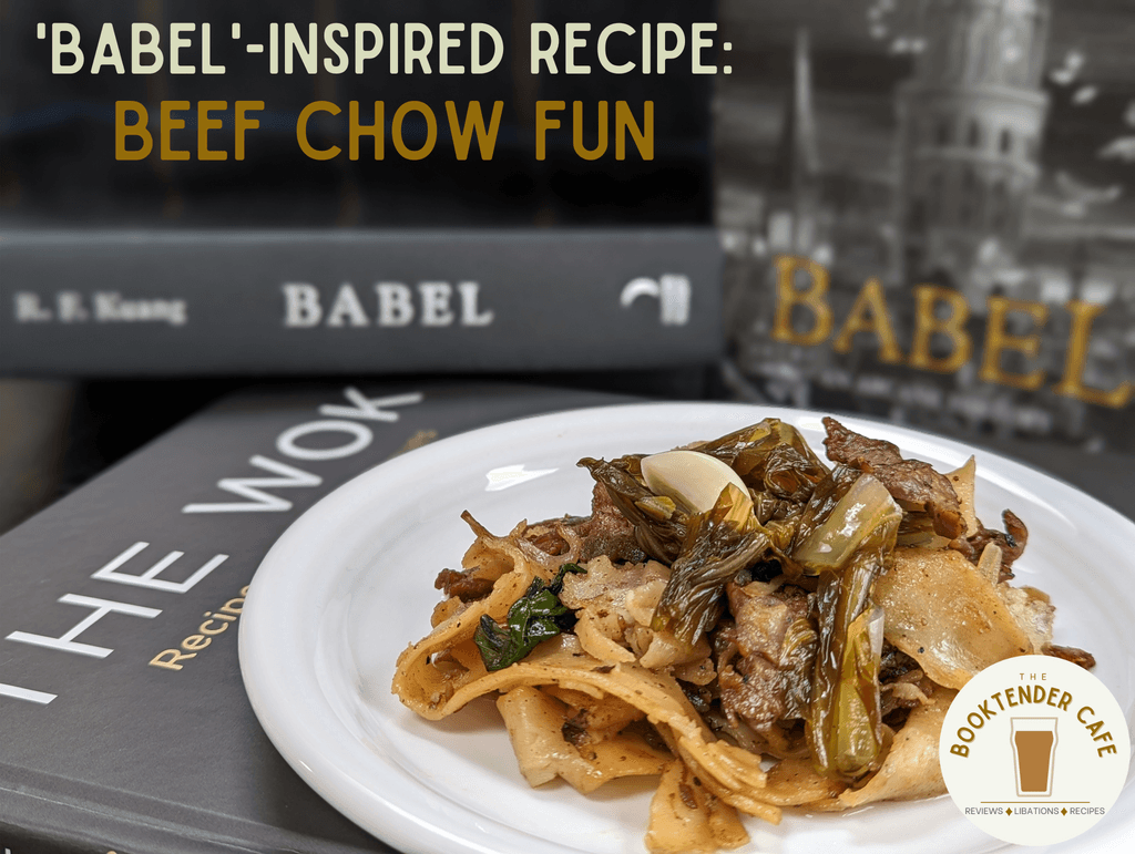 A plate of beef chow fun placed near copies of Babel by R.F. Kuang and The Wok by J. Kenji Lopez-Alt